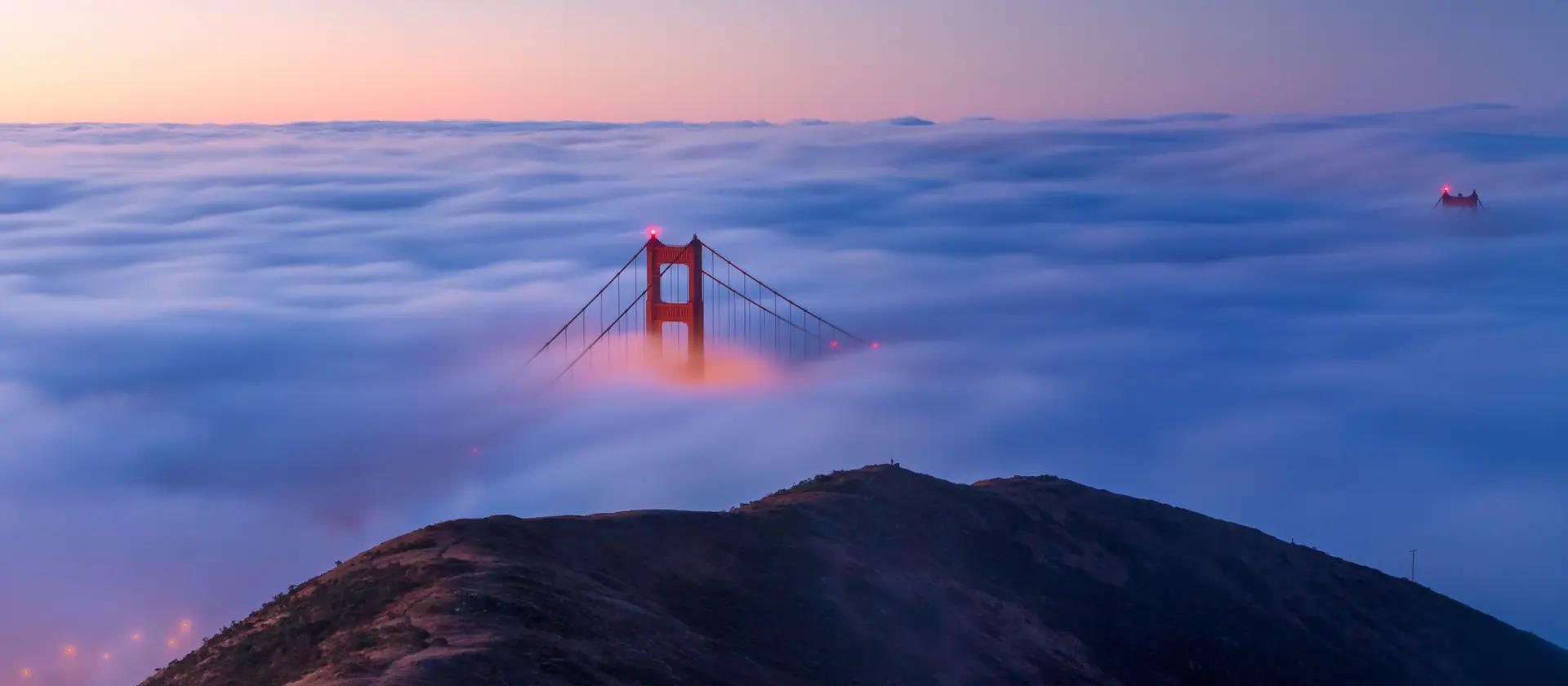 The Golden Gate Bridge rising out of the fog