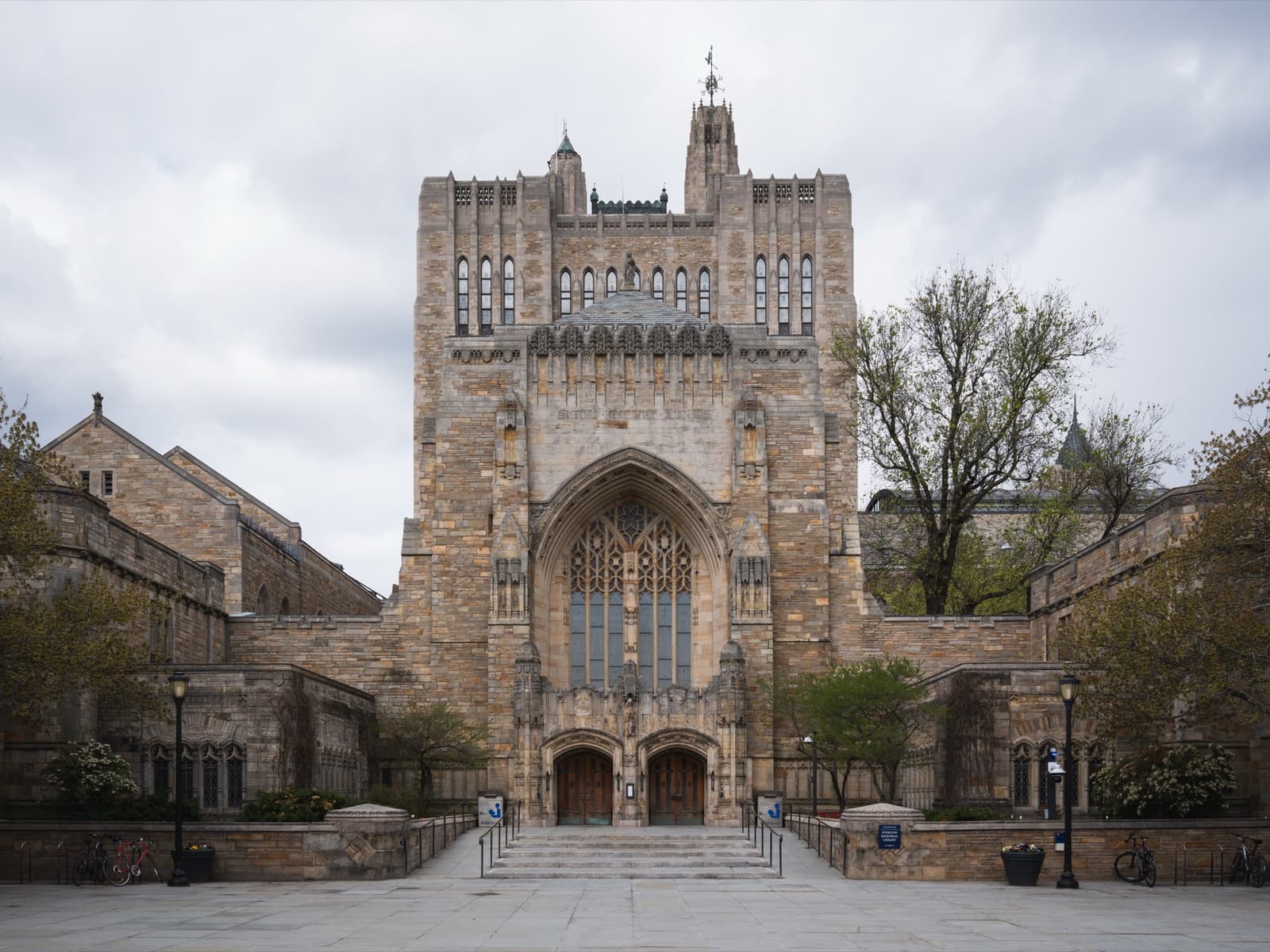 A Gothic stone library tower and entrance seen across a courtyard