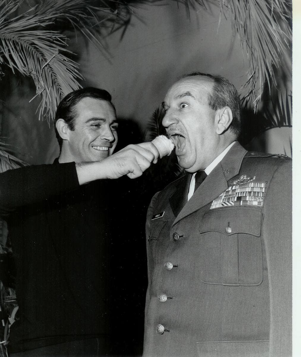Sean Connery pretending to push an ice cream cone at a uniformed officer