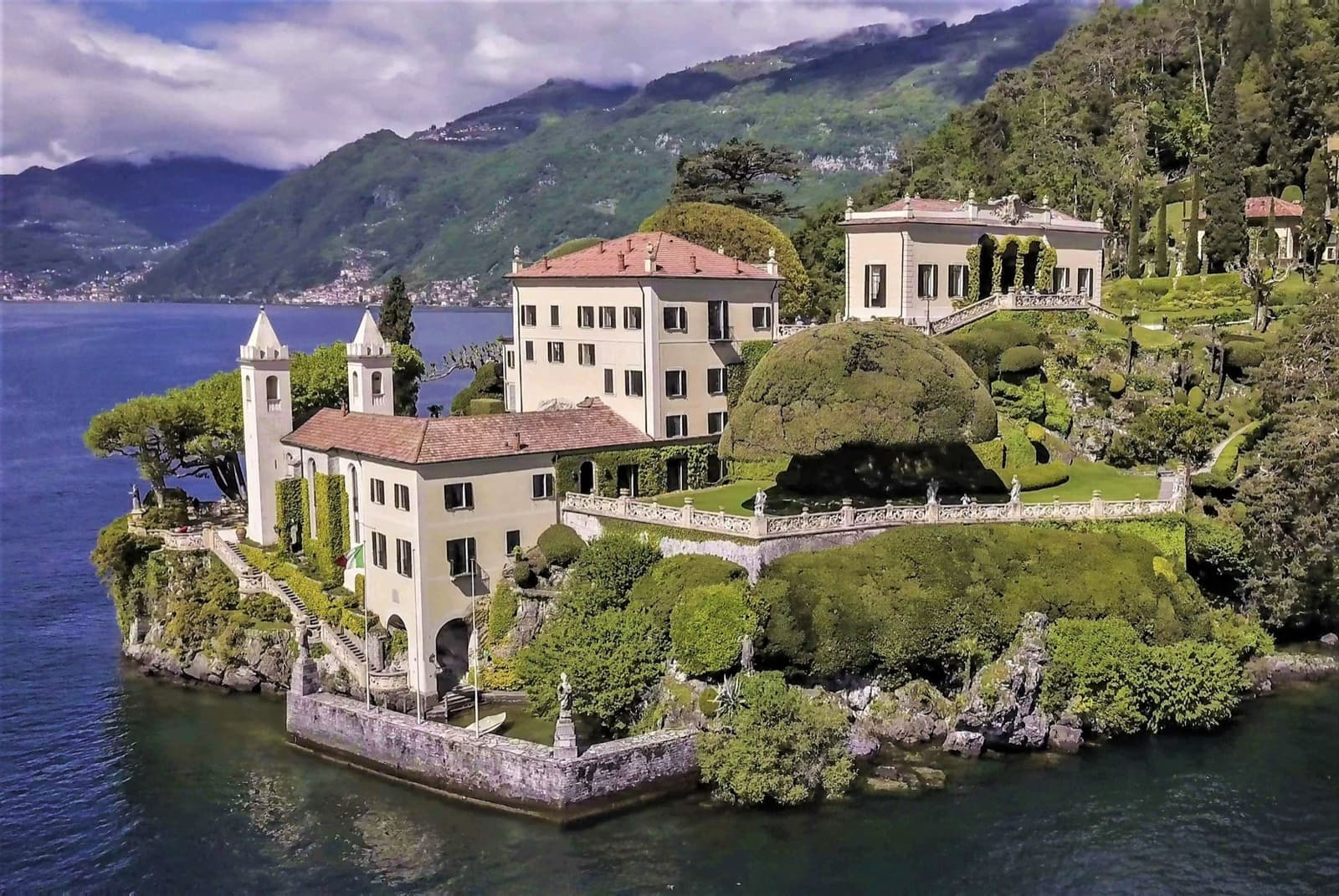 A villa with a loggia on a wooded promontory above Lake Como