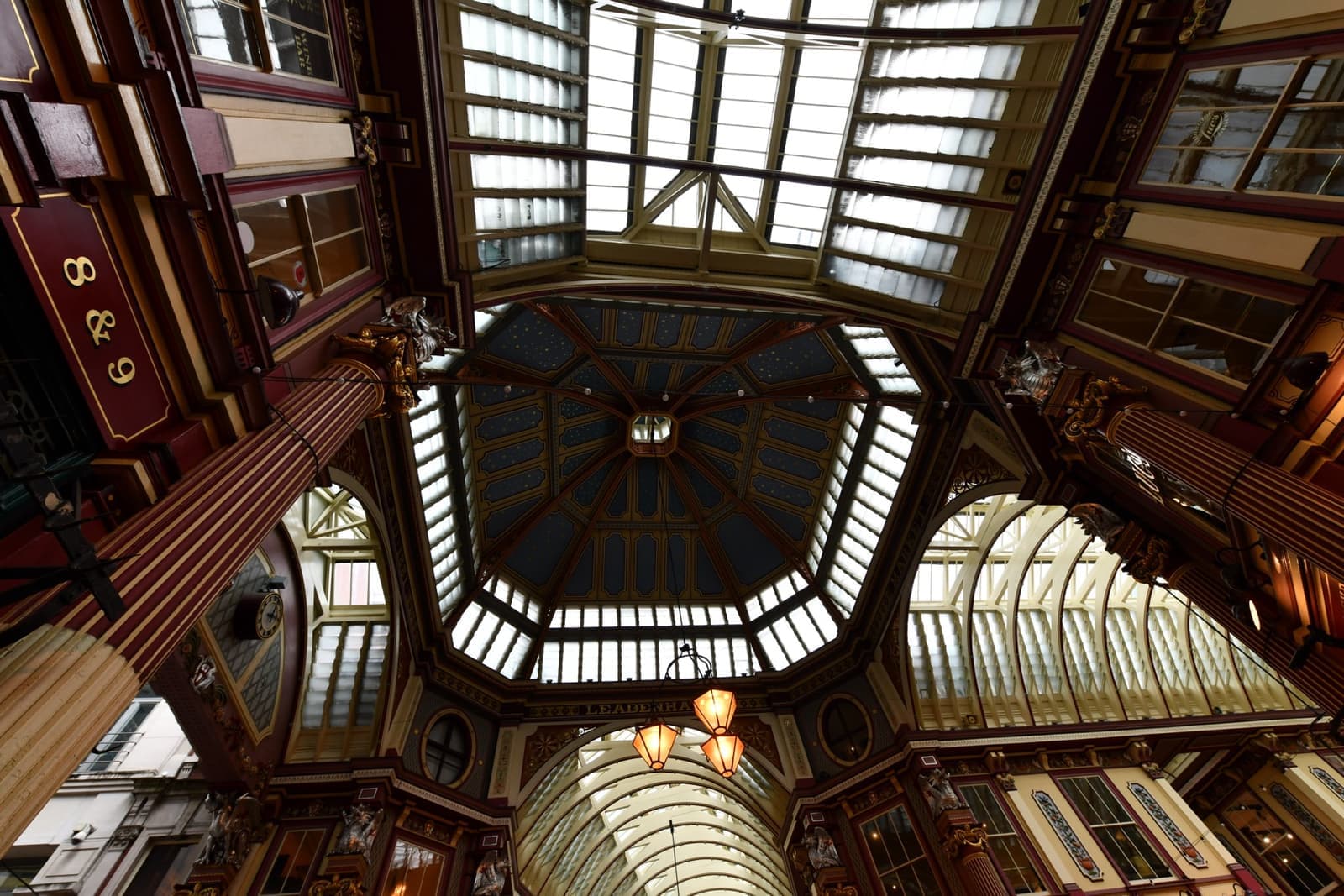 Looking up into a painted Victorian market roof and glazed lantern
