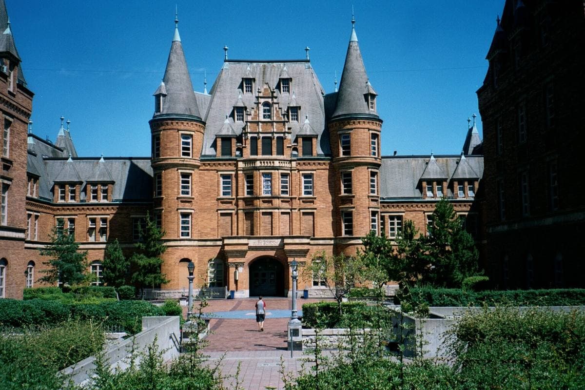 The turreted brick château of Stadium High School under a blue sky