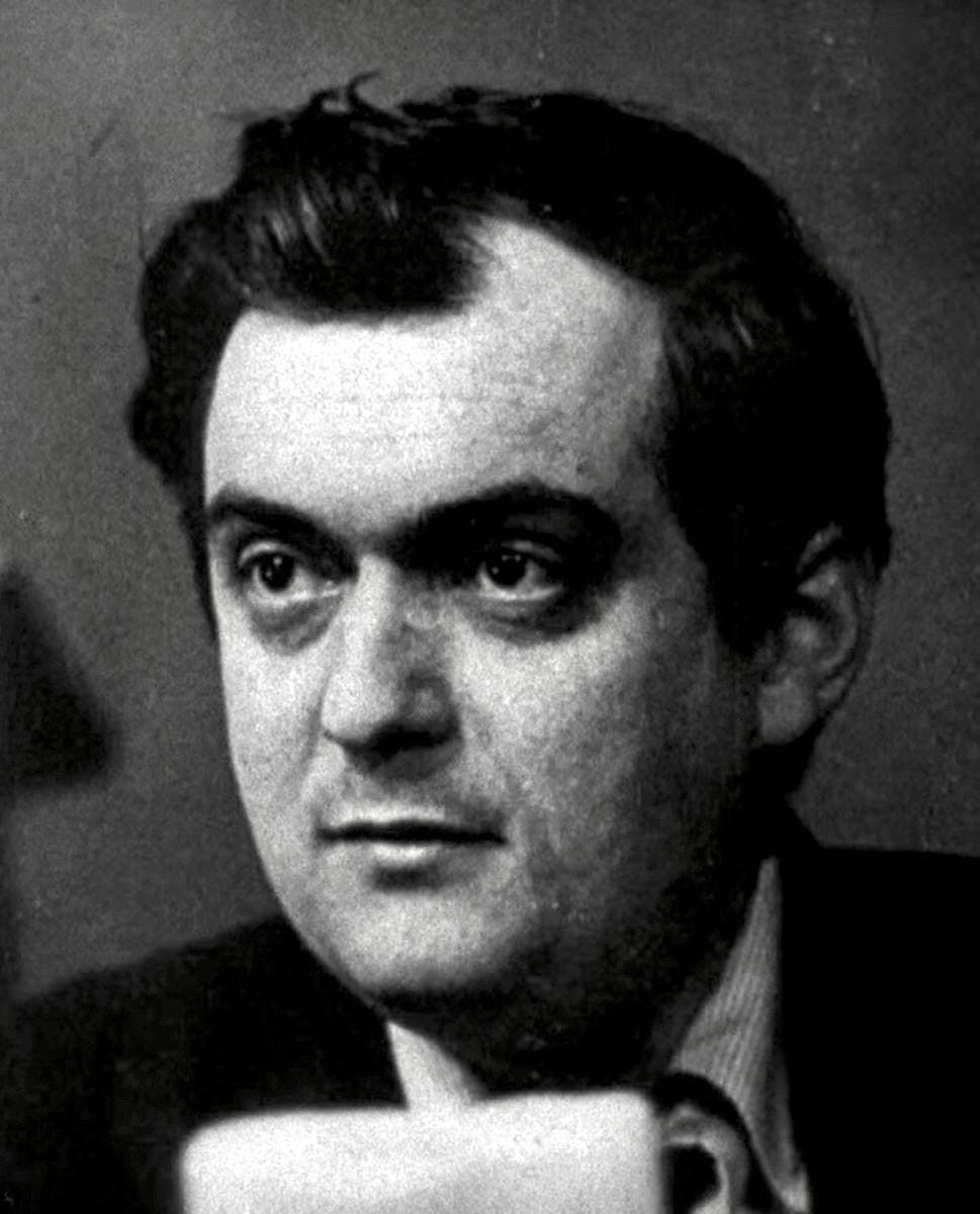 Stanley Kubrick, bearded, in a dark jacket, looking to one side