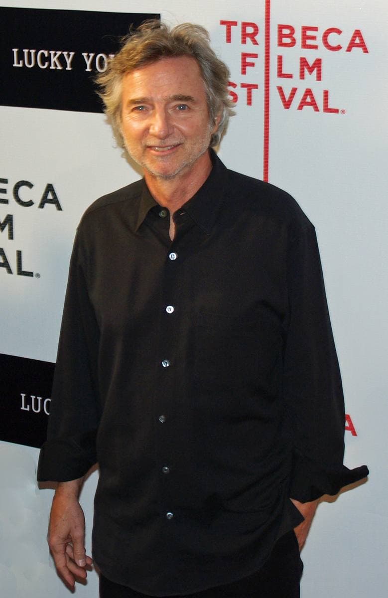 Curtis Hanson, grey-haired, in a dark jacket, looking at the camera