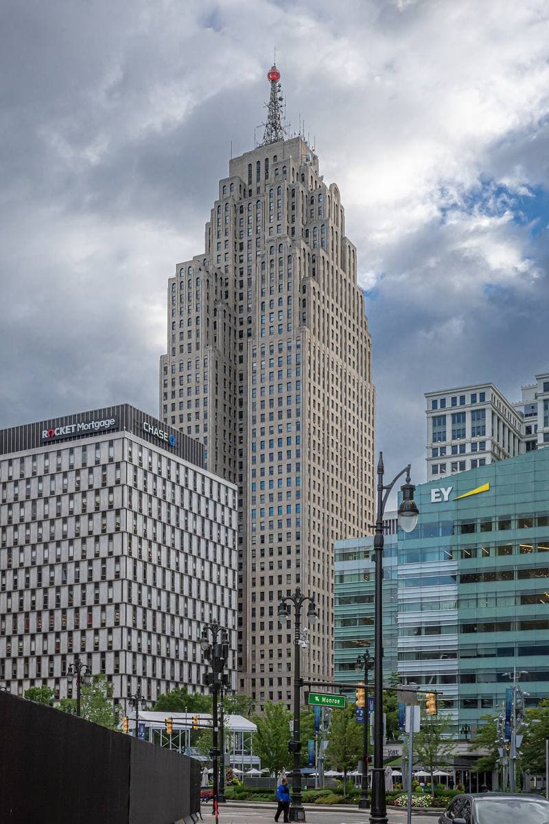 The tall stepped Art Deco Penobscot Building rising against an evening sky