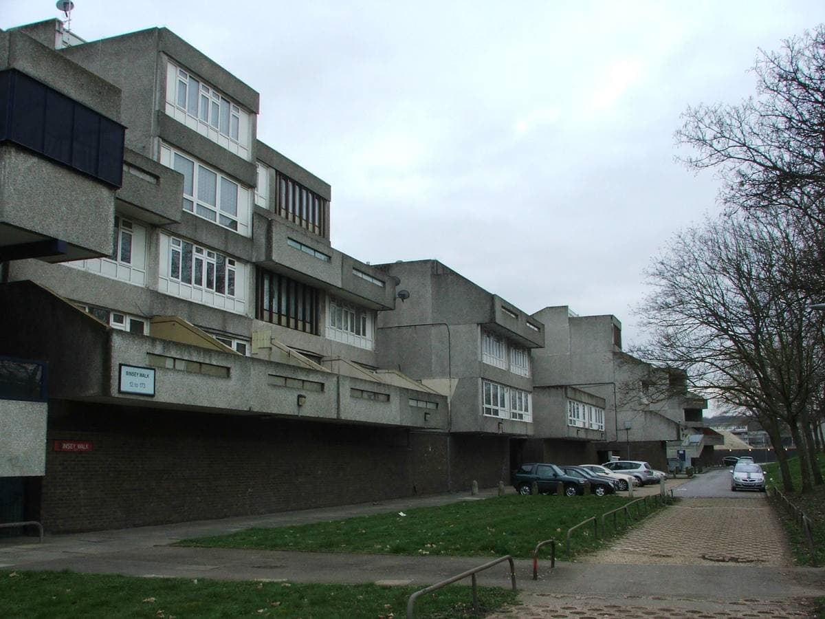 Stepped concrete flats along a raised walkway beside a strip of grass
