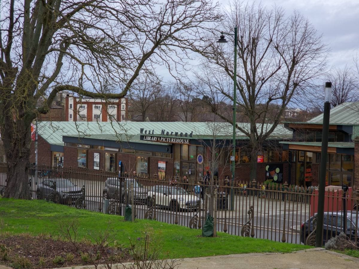 A low modernist library building with a cinema sign on Norwood High Street