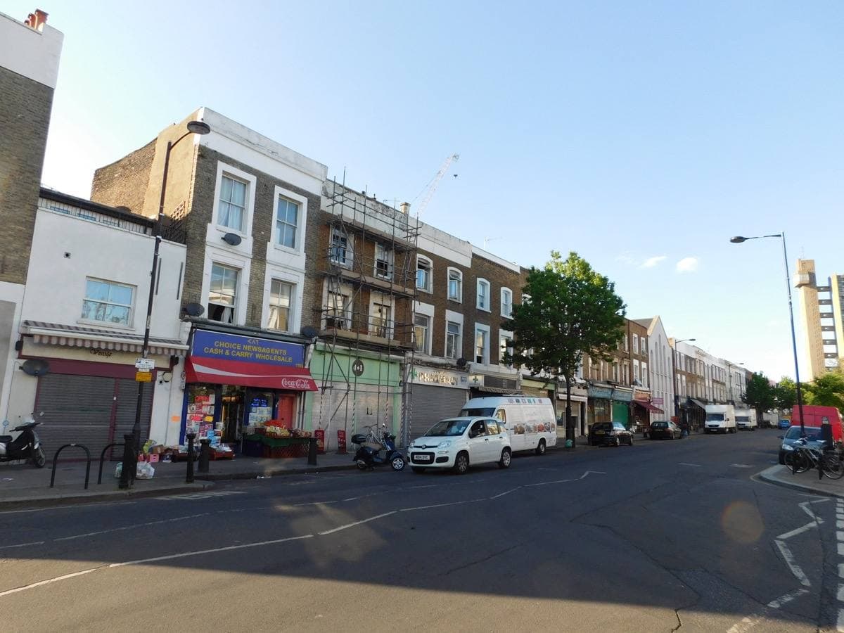 A street of low shops under a clear sky