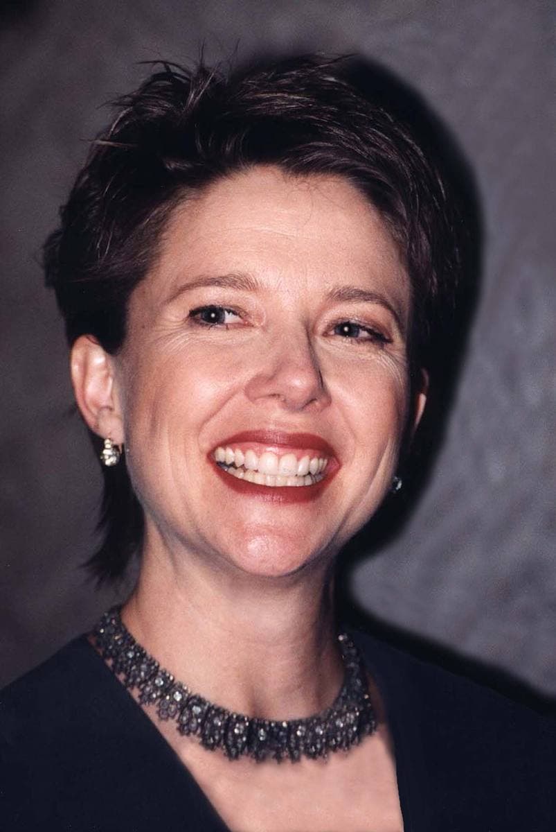 Annette Bening laughing, short dark hair, a beaded choker
