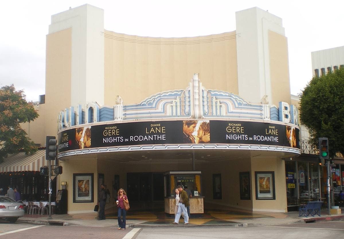 A streamline cinema with a curved wrap-around marquee on a corner