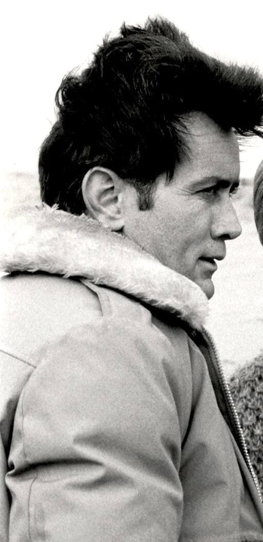 Martin Sheen in a fleece-collared jacket on a windy beach
