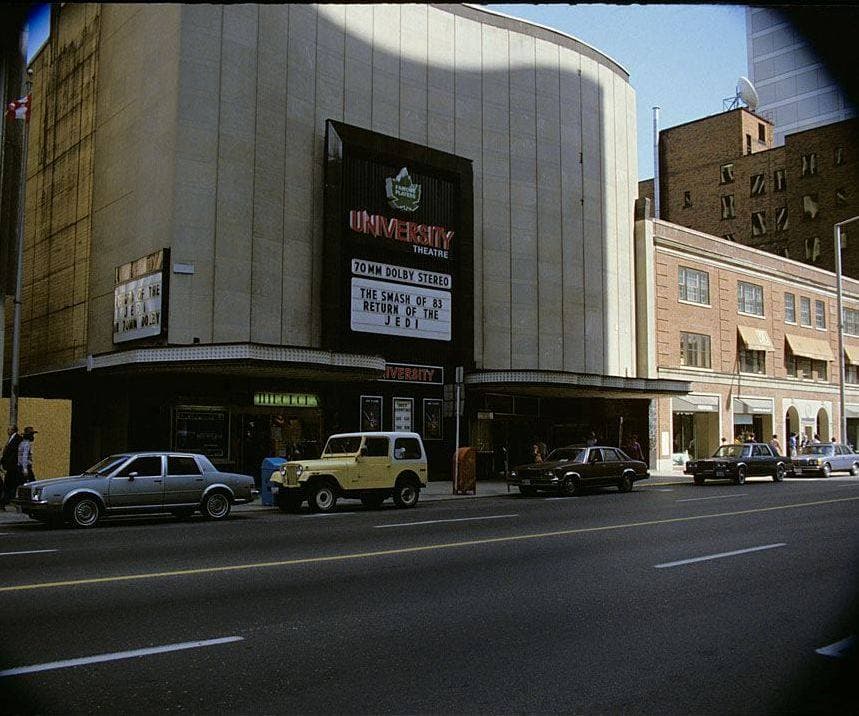 A cinema front on a city street with a big marquee