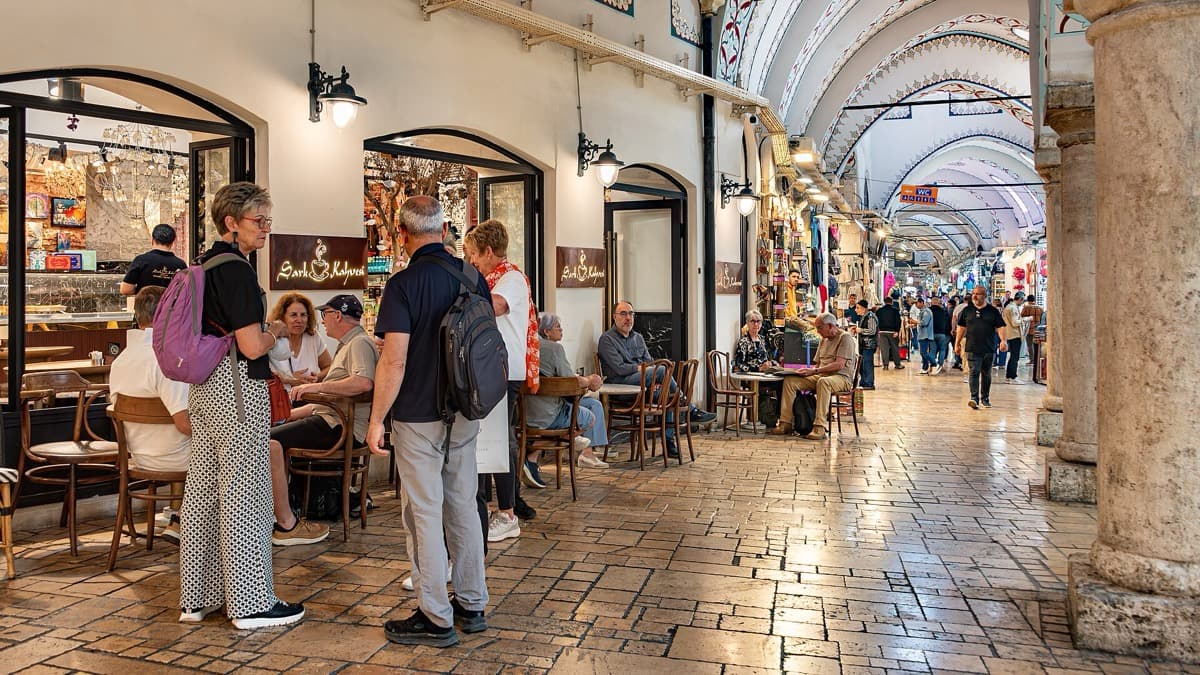 A covered bazaar passage with hanging lamps and shop fronts