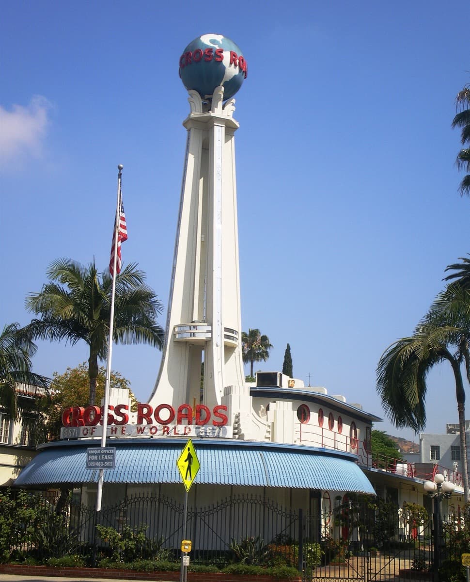 A white ship-shaped Streamline Moderne building with a tall tower