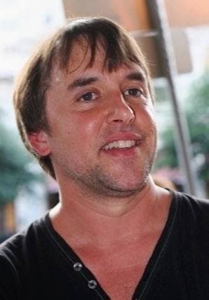Richard Linklater smiling, in a dark T-shirt