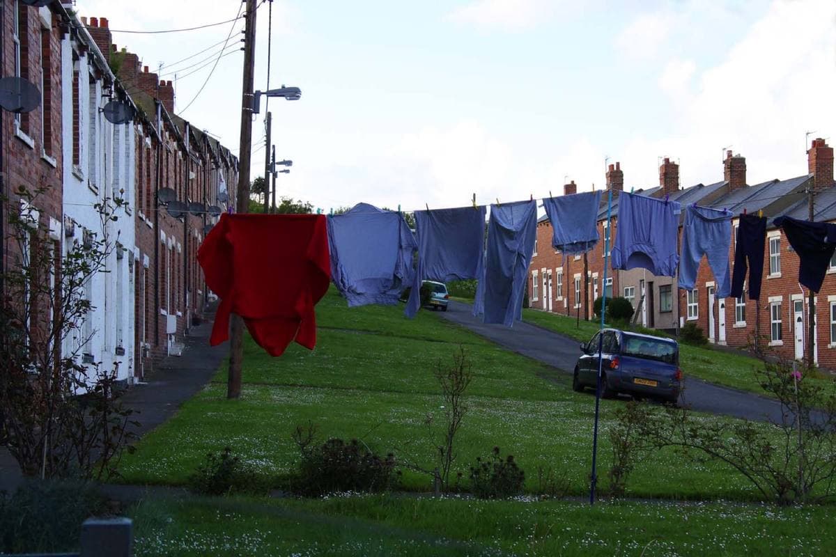 Washing lines strung across the grass between two terraces