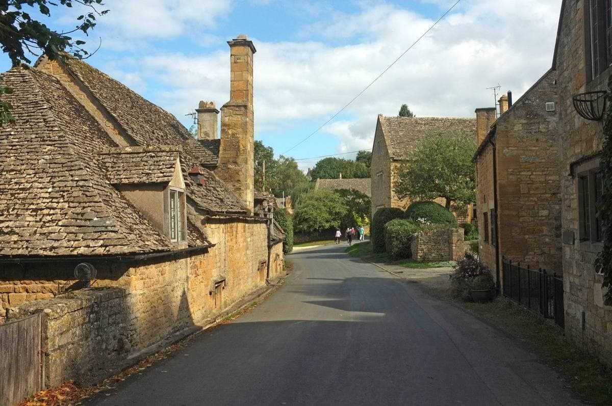 Cotswold stone cottages along a quiet village lane