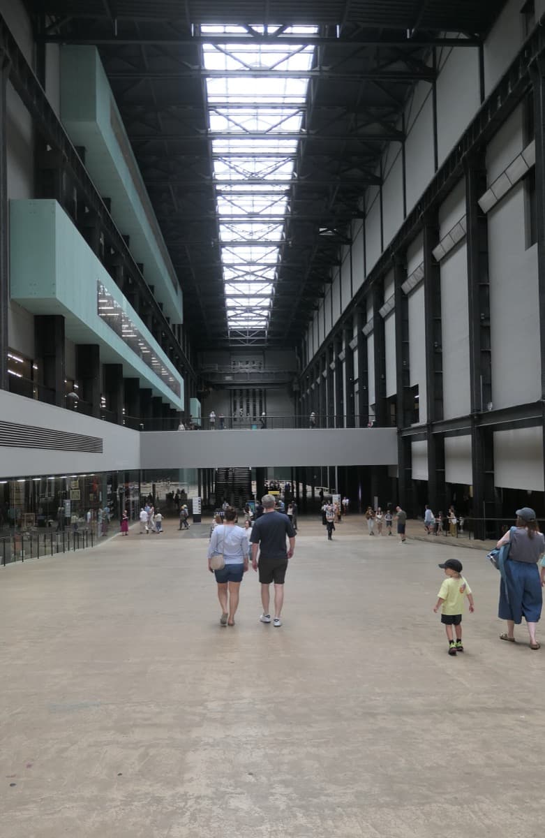 The long, high Turbine Hall at Tate Modern, with visitors on its sloping floor