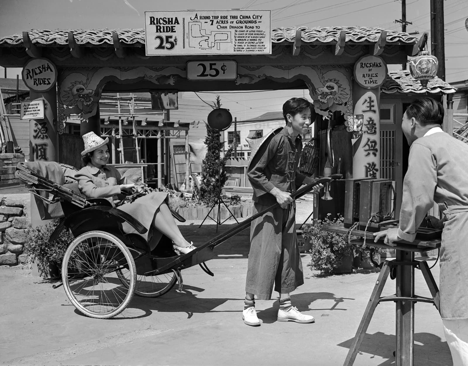 A black-and-white street scene: a woman in a rickshaw, its puller, and a sign offering rides through China City for 25 cents