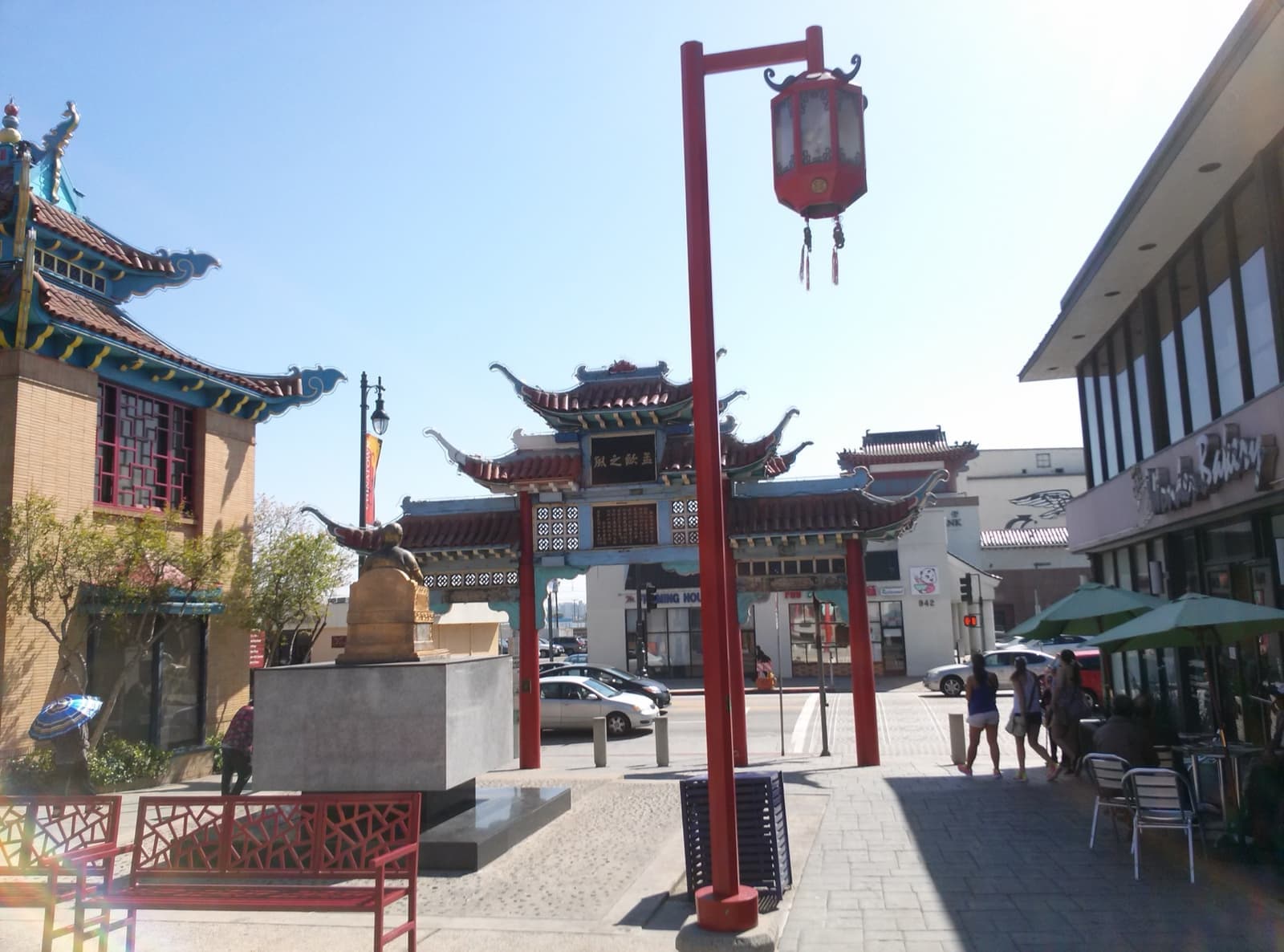 A plaza with a red lantern post and a Chinese-style gate