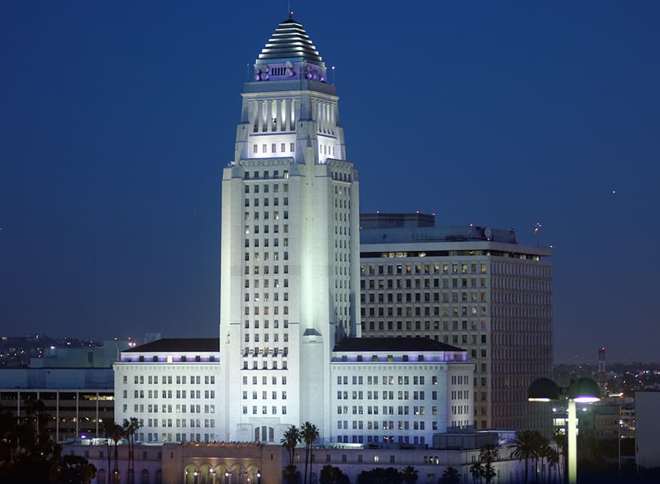 The white tower of City Hall lit against a deep blue sky
