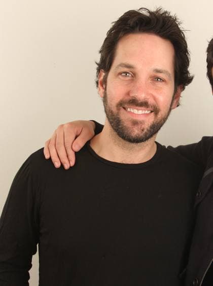 Paul Rudd smiling, dark hair and beard, black T-shirt