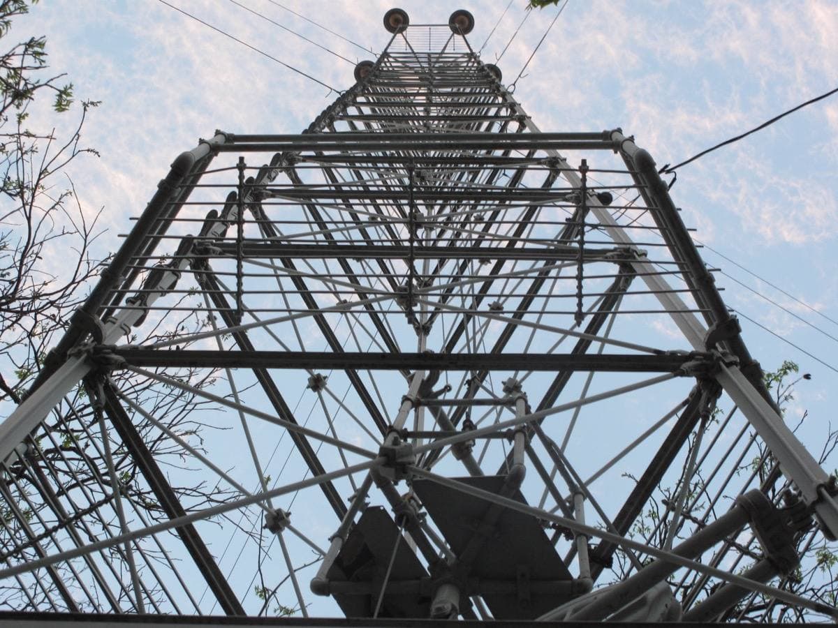 Looking straight up through the steel legs of a moonlight tower