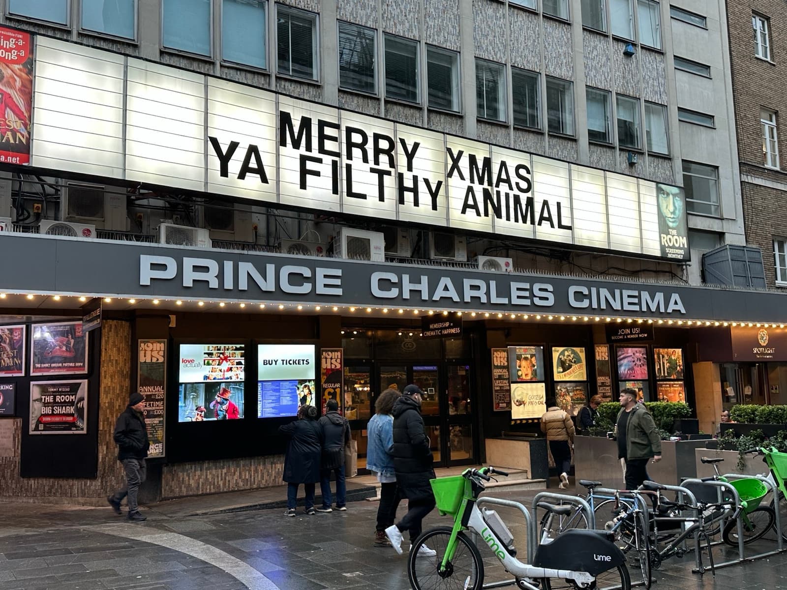 A cinema frontage with a lettered marquee in Leicester Place