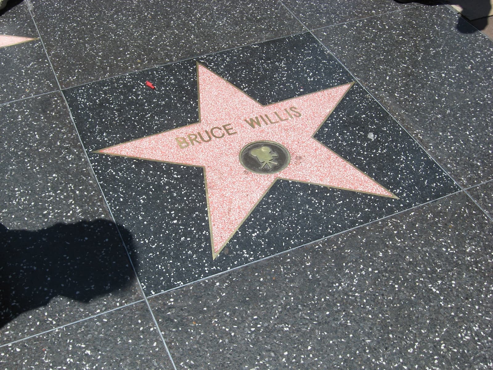 A pink terrazzo star with Bruce Willis’s name in brass