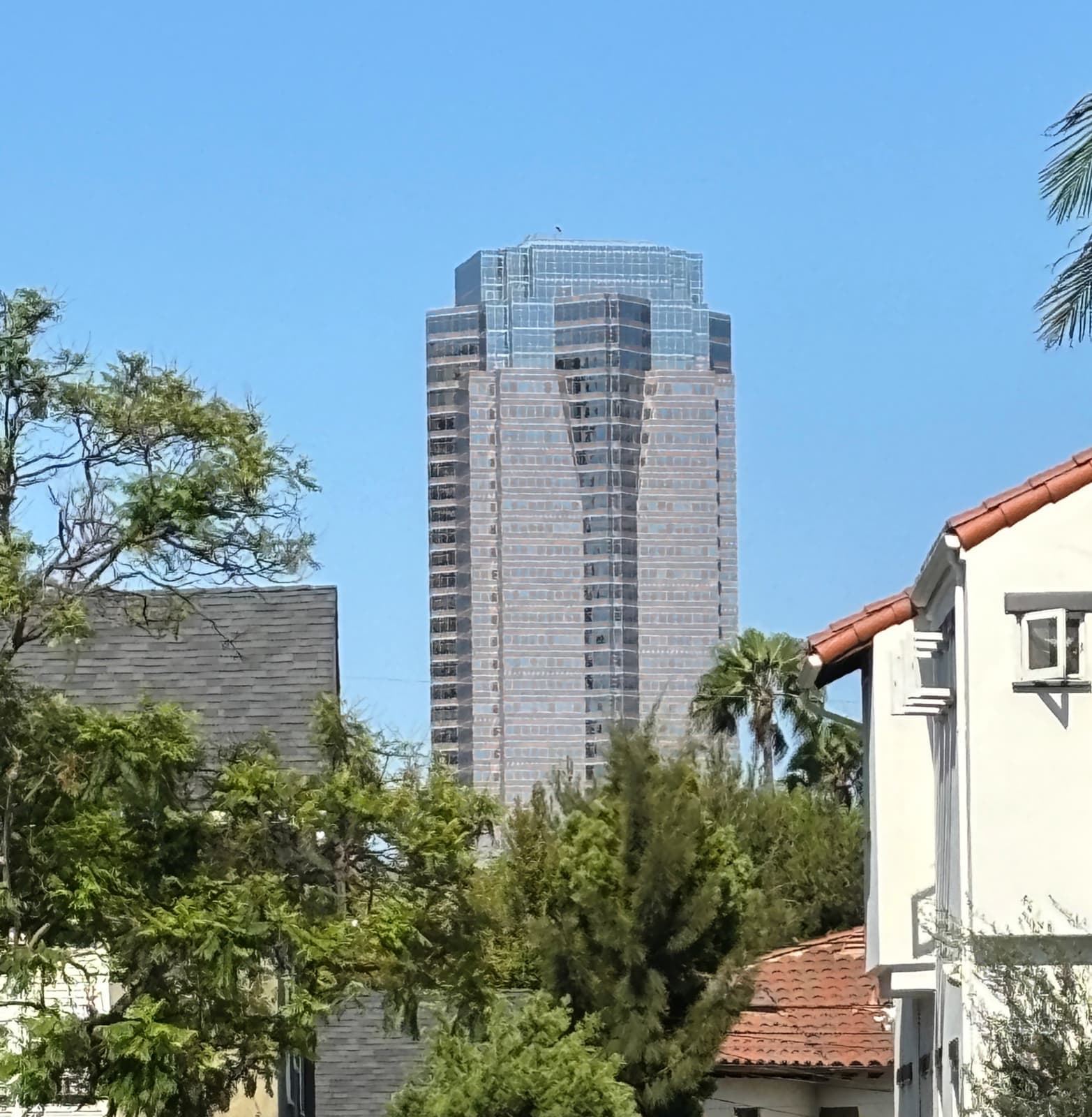 Fox Plaza rising above trees on Avenue of the Stars