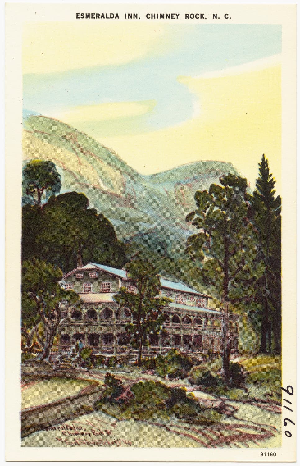 A coloured postcard of a wooden inn among trees below a steep mountain