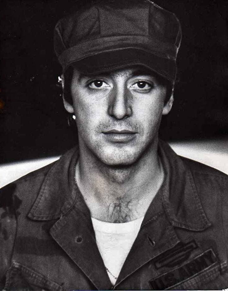 Al Pacino in an army cap, looking straight at the camera