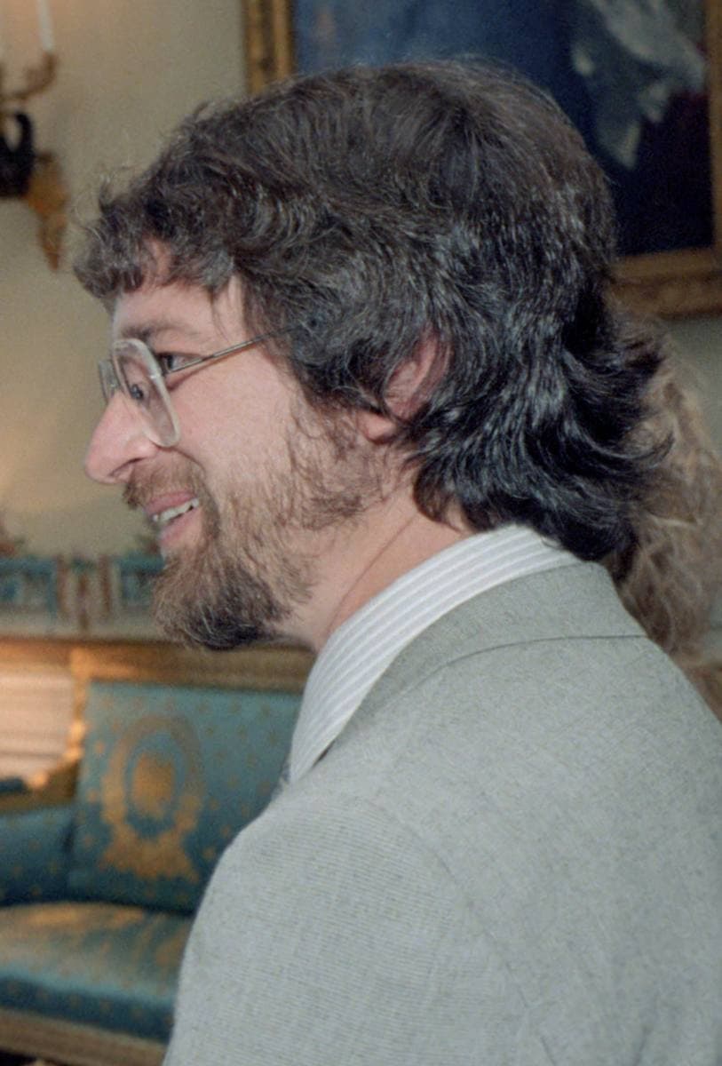 A young, bearded Steven Spielberg in glasses and a grey jacket in the Blue Room