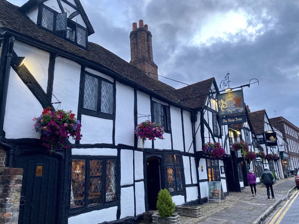 A black-and-white timber-framed inn on a village high street