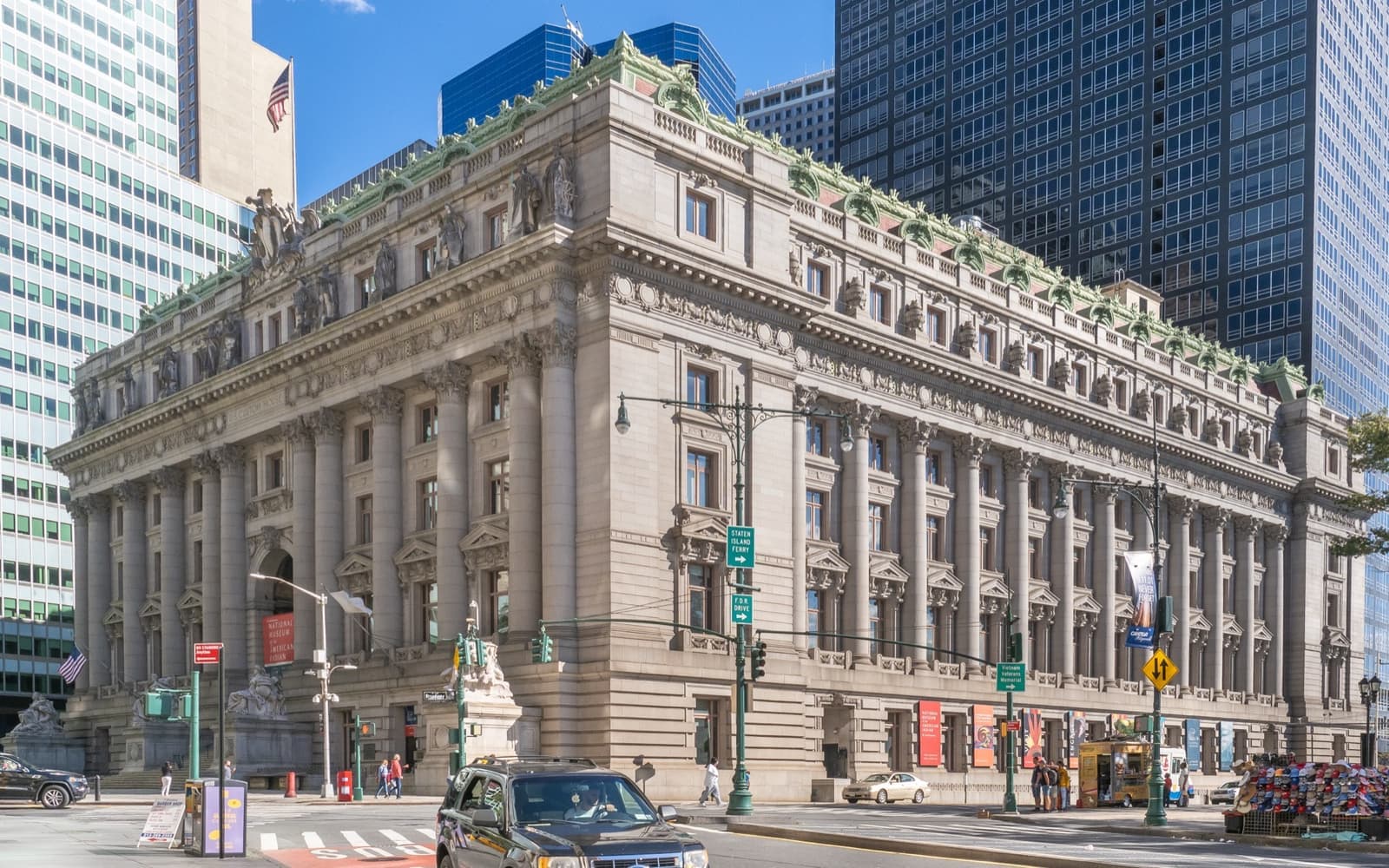 A grand Beaux-Arts stone building with columns and statues