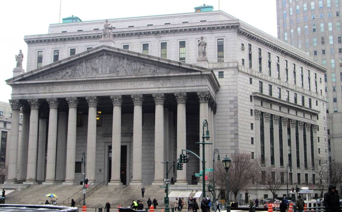 Colour photograph of a granite courthouse with a columned portico and wide steps