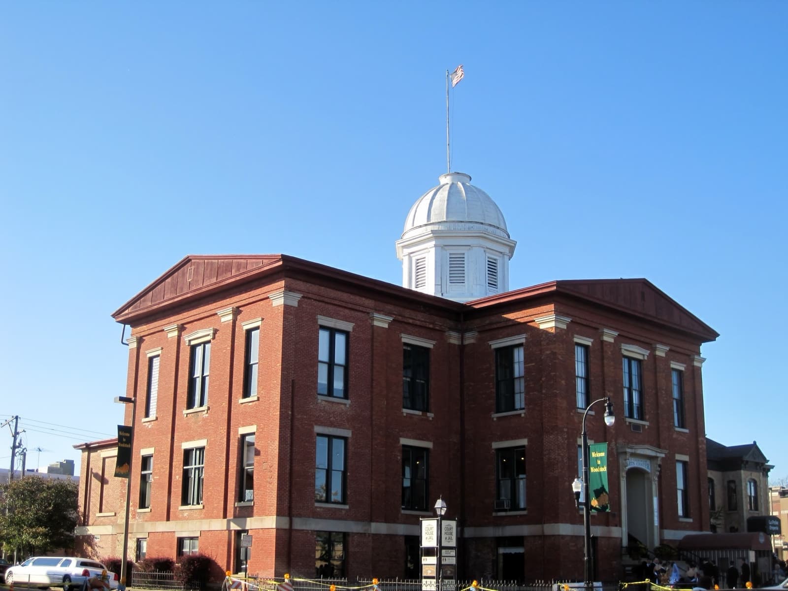A red-brick Italianate courthouse with a white dome against a blue sky