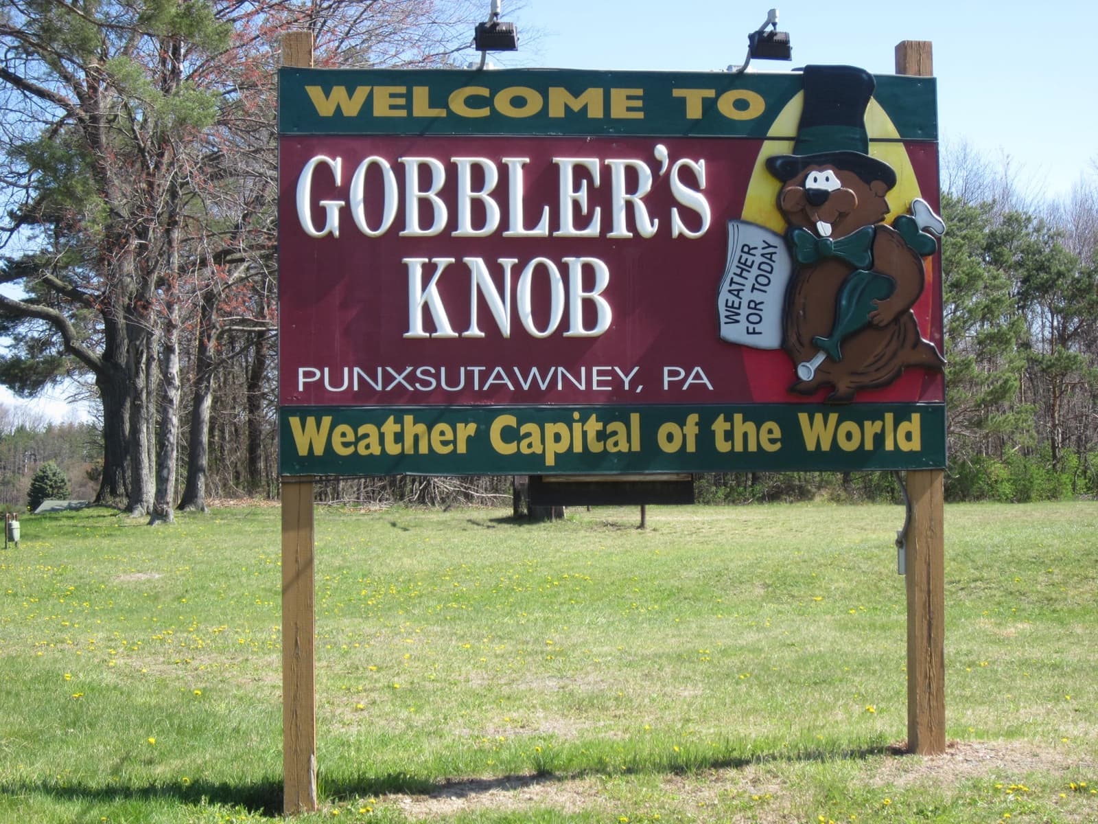 A painted wooden sign reading Welcome to Gobbler’s Knob, Punxsutawney, Weather Capital of the World