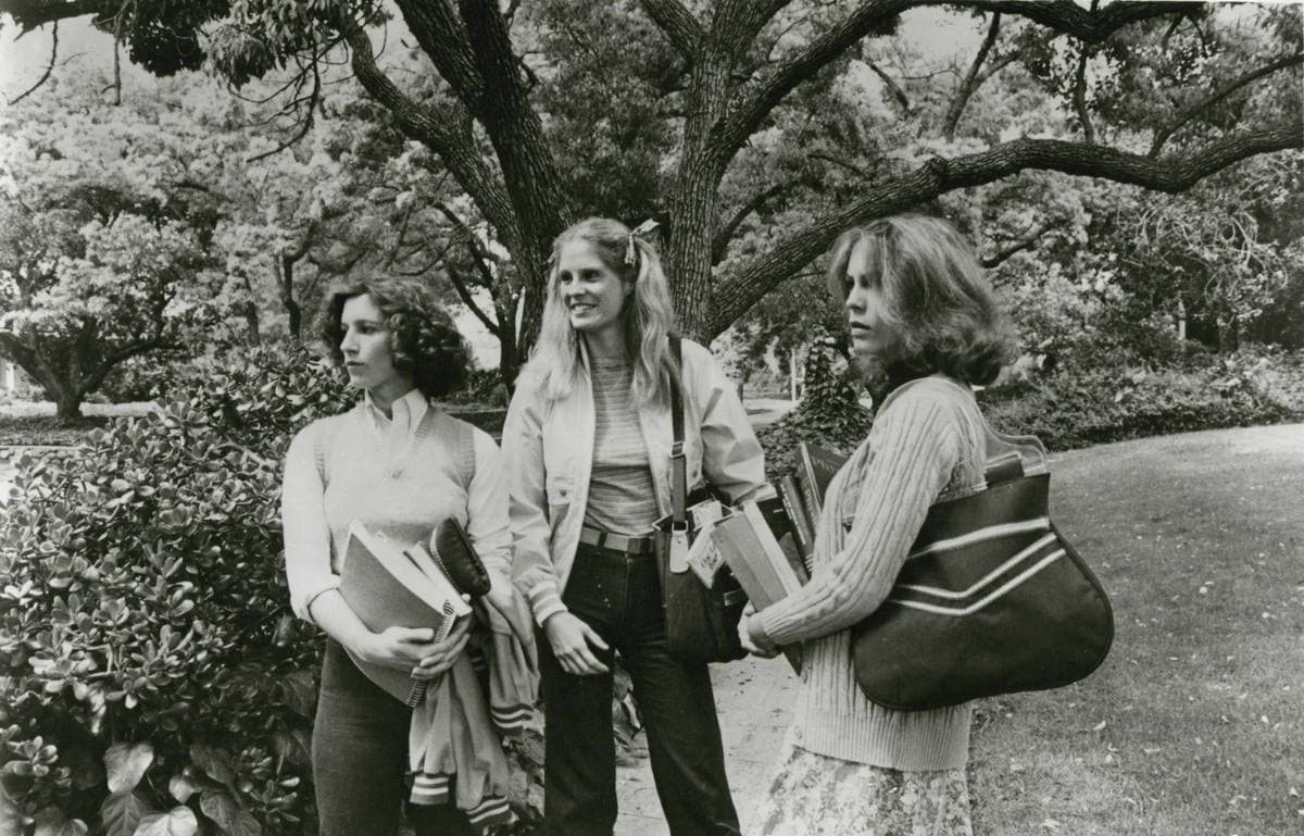 Three teenage friends walking together in a 1978 still from Halloween