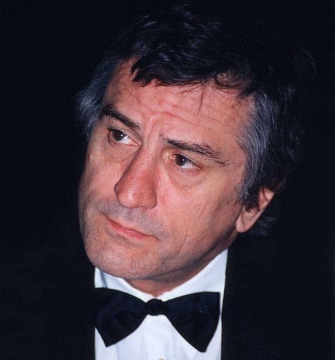 Robert De Niro in a black bow tie, looking to one side