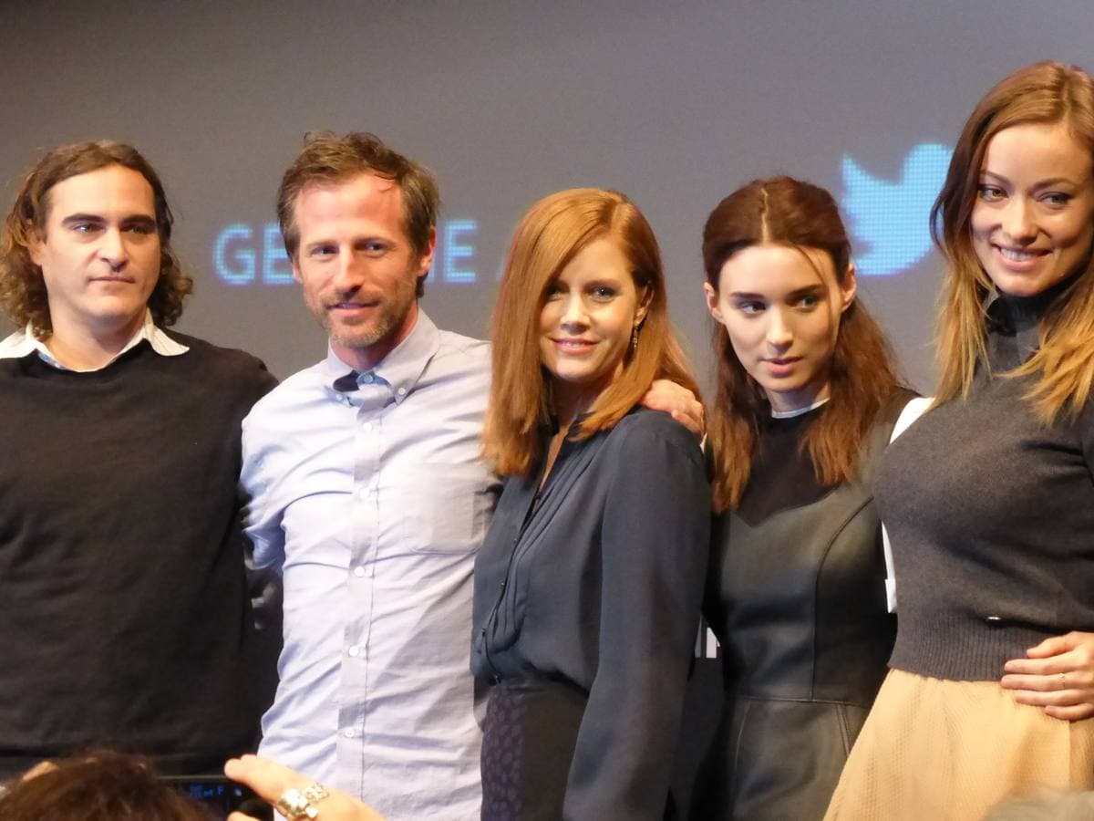 Five people stand in a row on a stage: Joaquin Phoenix in a dark jumper, Spike Jonze in a pale shirt, Amy Adams, Rooney Mara and Olivia Wilde
