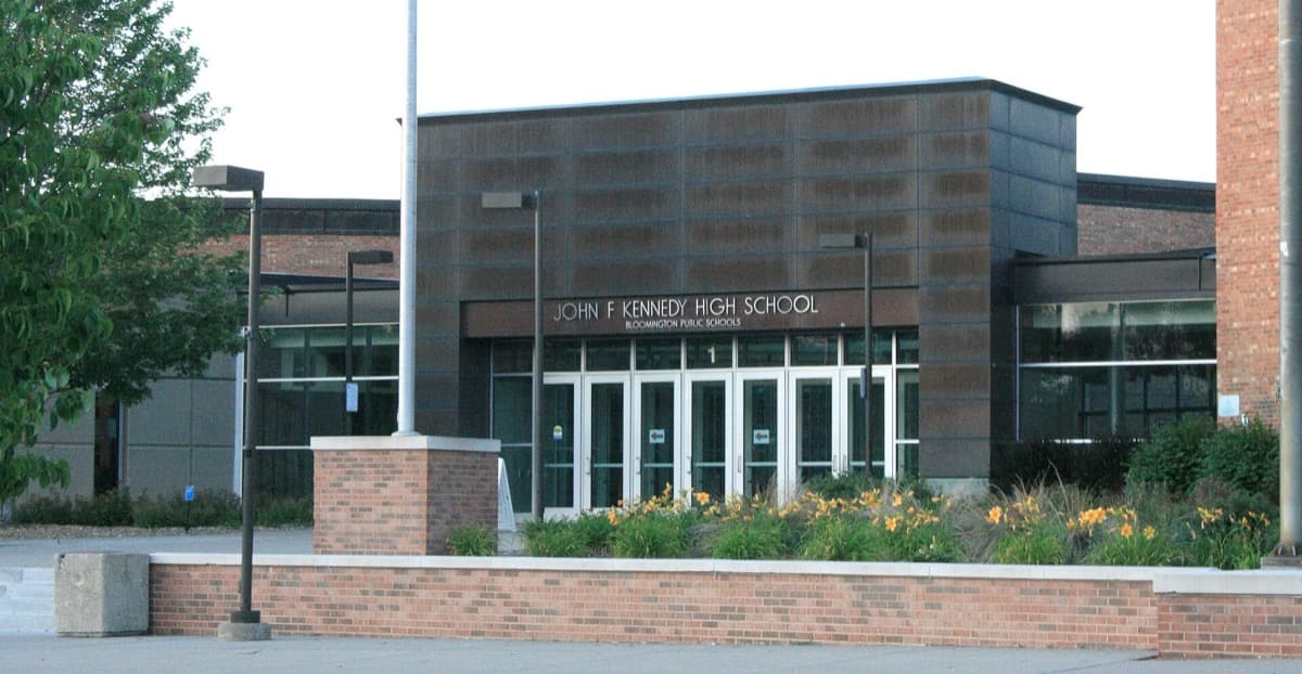 A low brick school entrance under a clear sky
