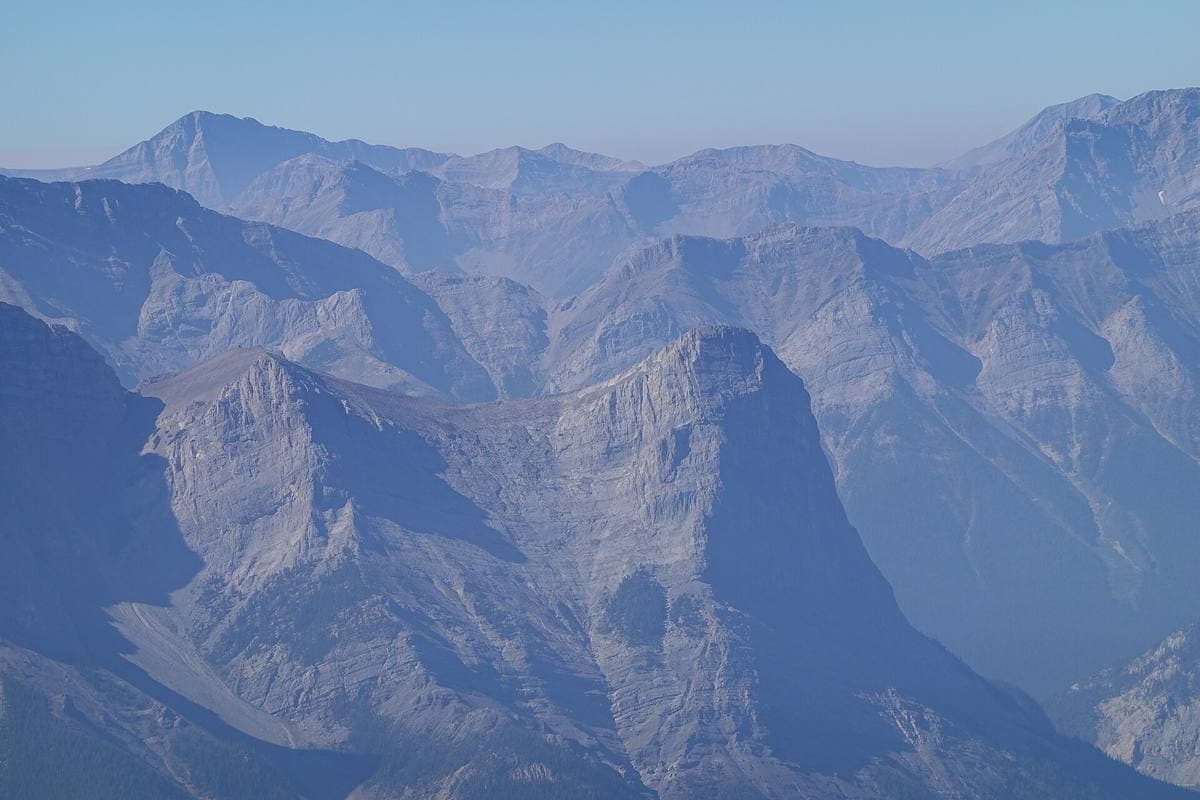 Grey limestone peaks and ridges under a pale sky