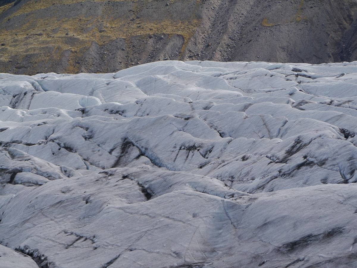 Close view of ridged grey-white glacier ice