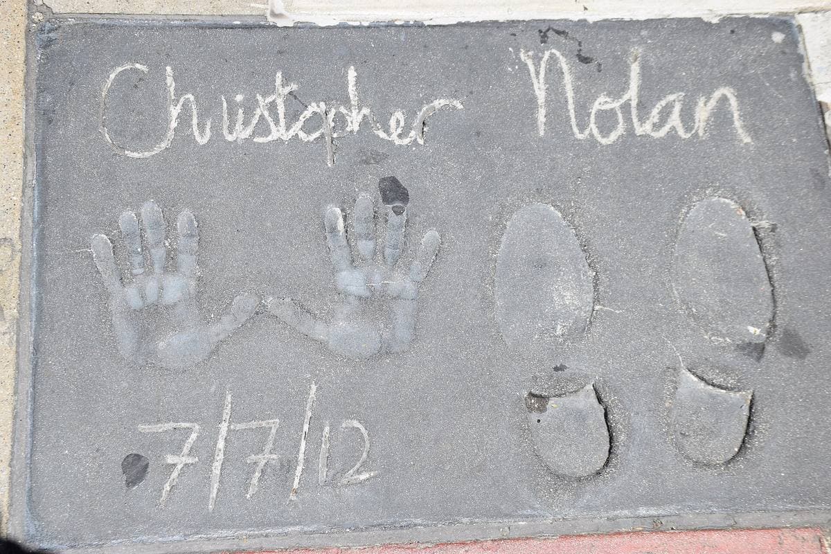 Handprints, footprints and a signature in grey concrete