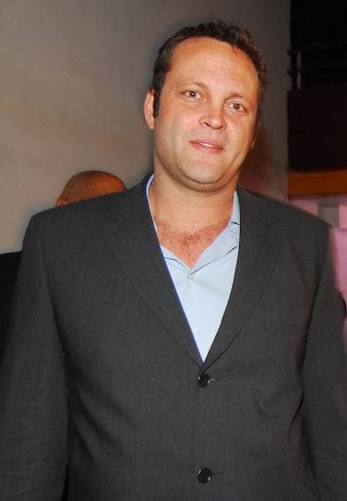 Vince Vaughn in a grey suit and open blue shirt