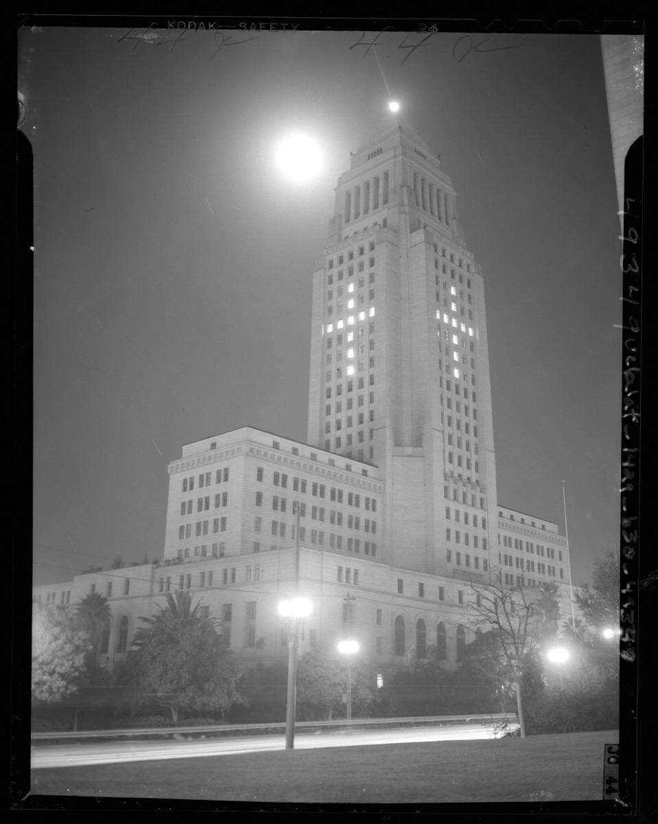 Los Angeles City Hall tower at night, its lit windows forming a cross