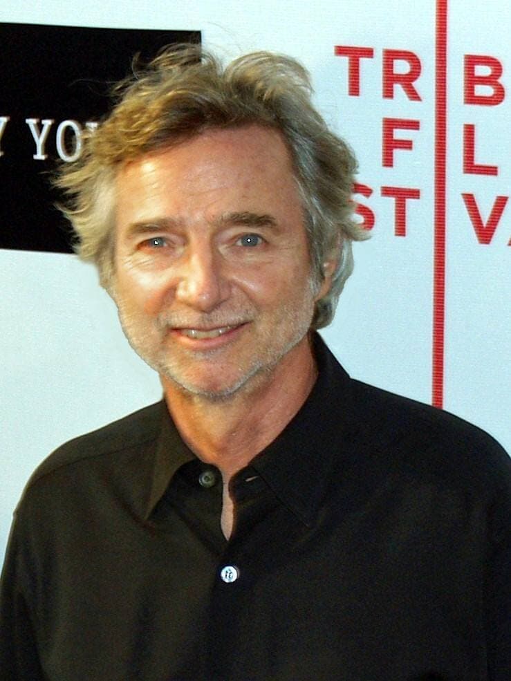 Curtis Hanson in glasses and a dark jacket