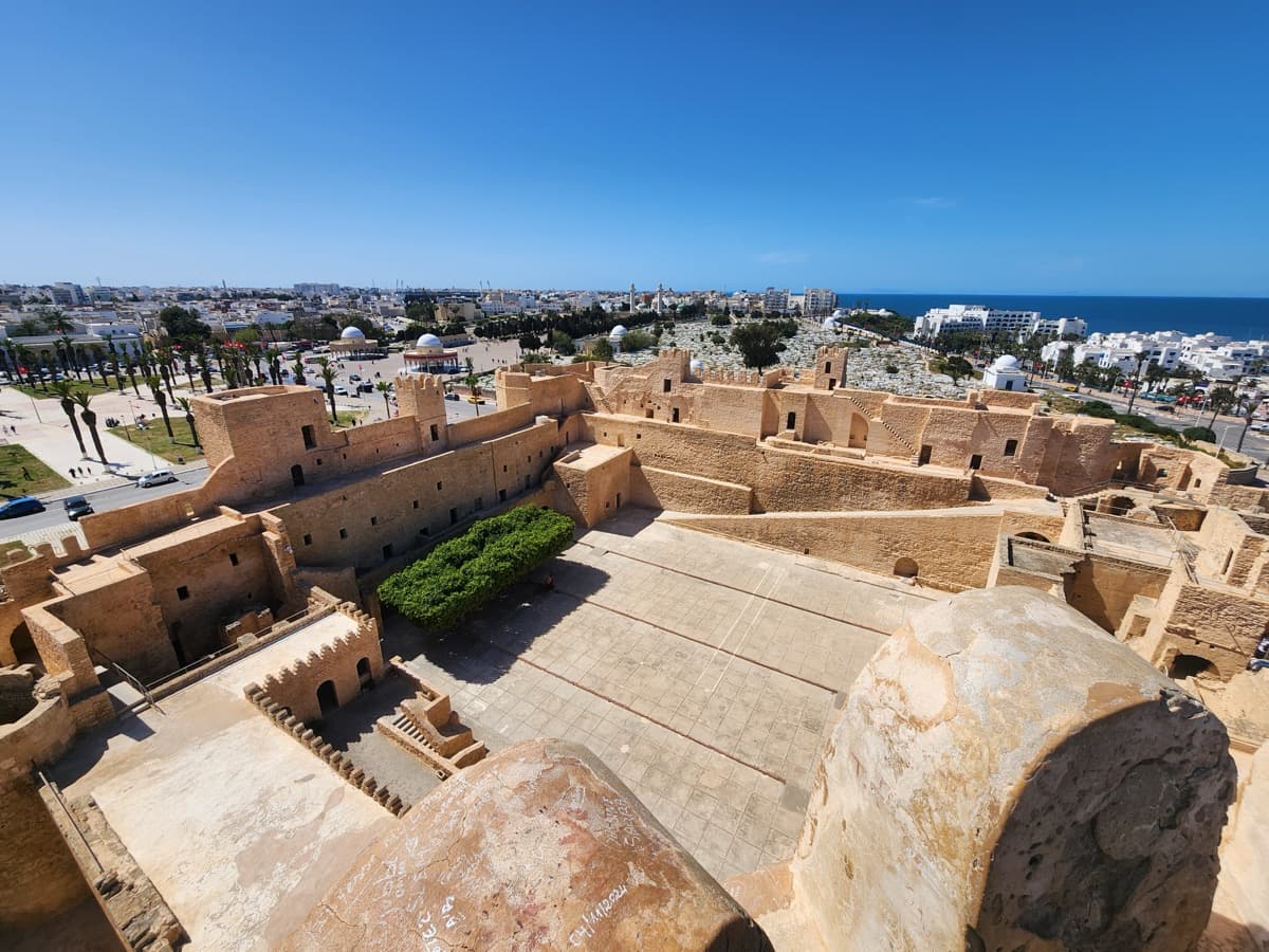 The sandy-coloured walls and tower of the Ribat of Monastir under a blue sky