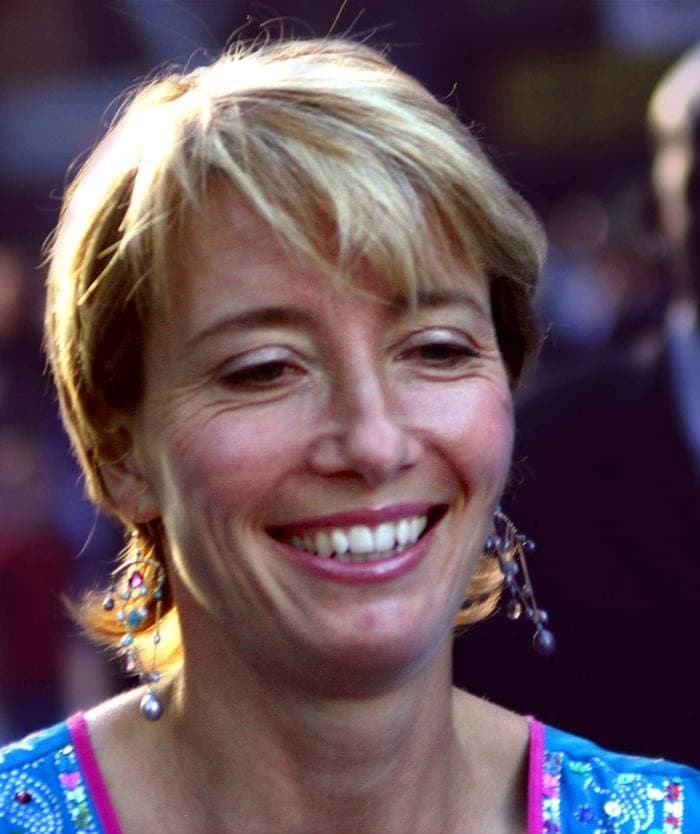 Emma Thompson smiling, with short fair hair and drop earrings